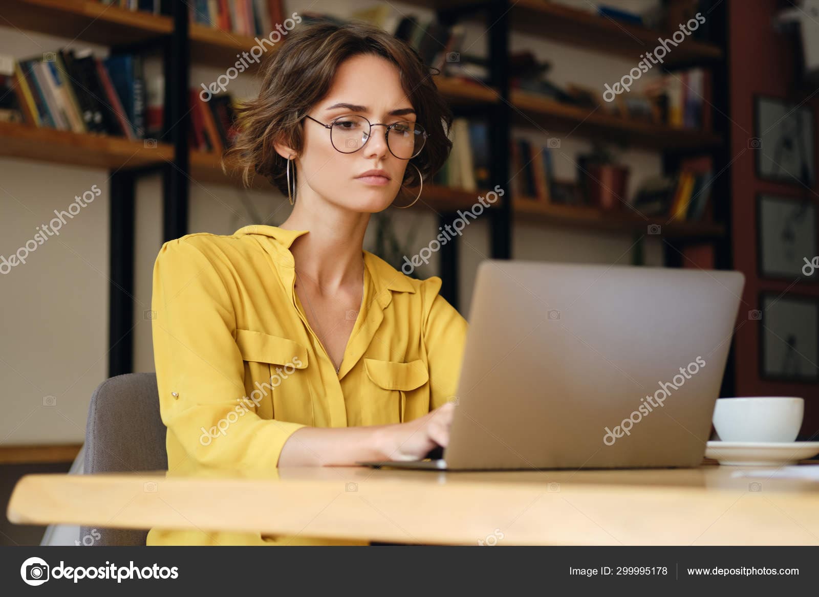 Stock photo young serious businesswoman in eyeglasses.