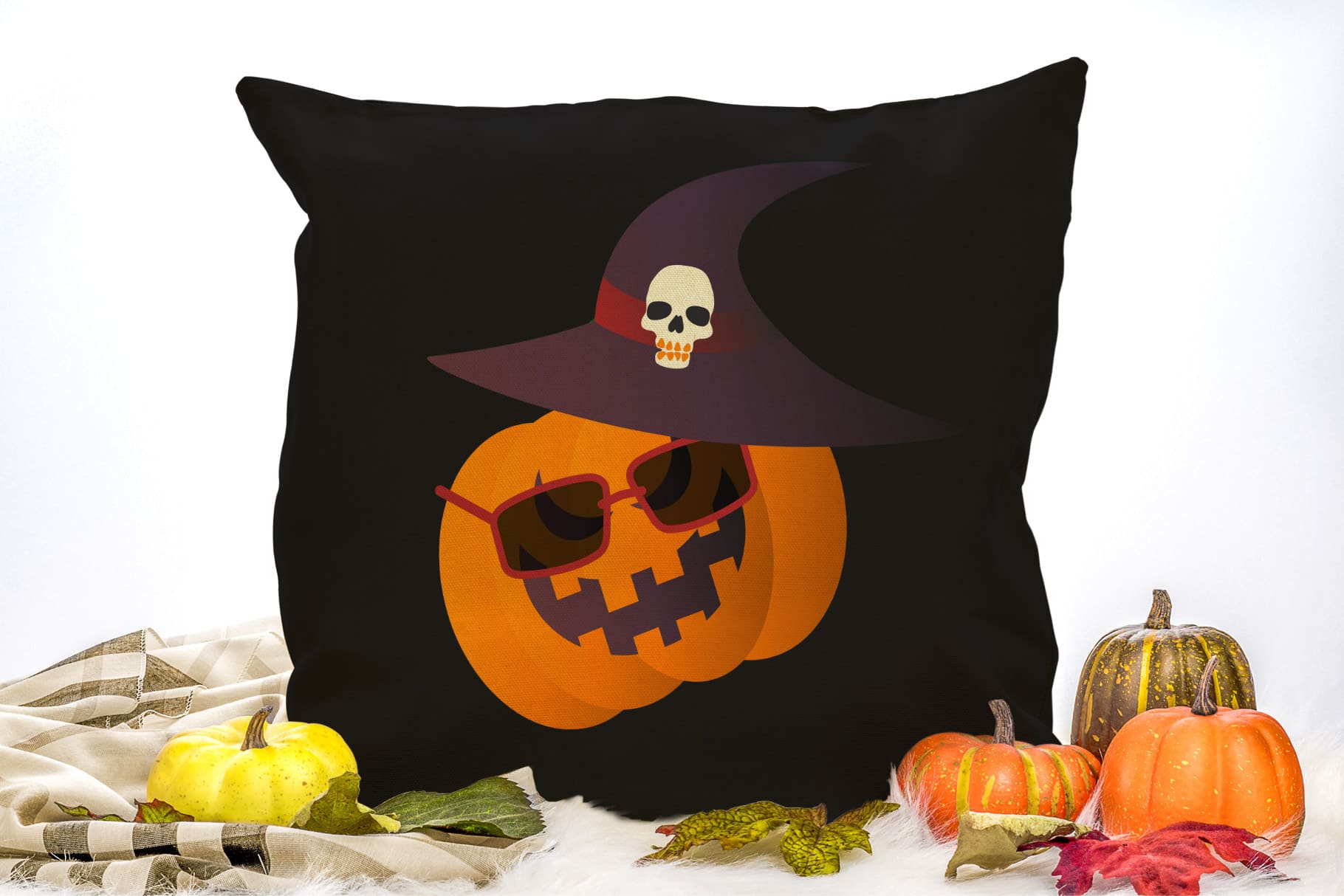 Black decorative pillow with orange pumpkin in glasses.