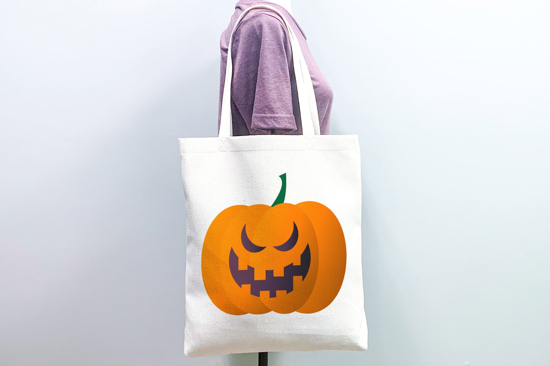 A large white eco-friendly bag with an embossed pumpkin and a wicked grin.