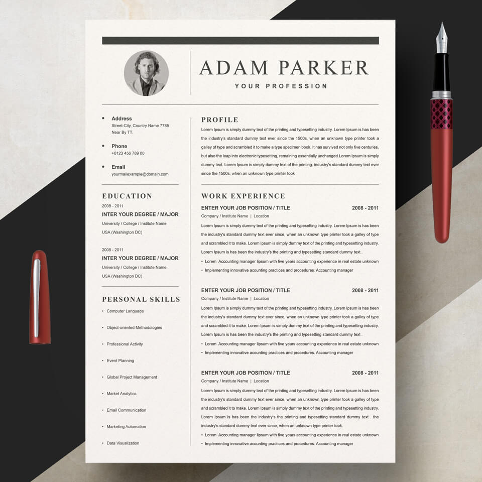 Professional resume with a red pen on top of it.