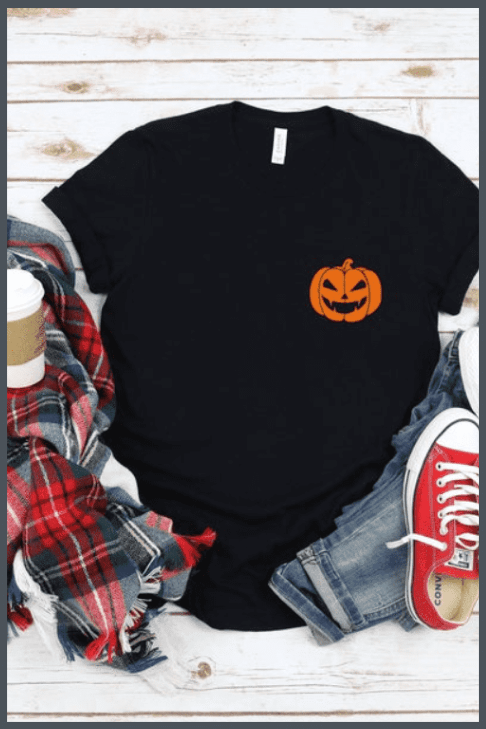Black minimalistic T-shirt with a small pumpkin.