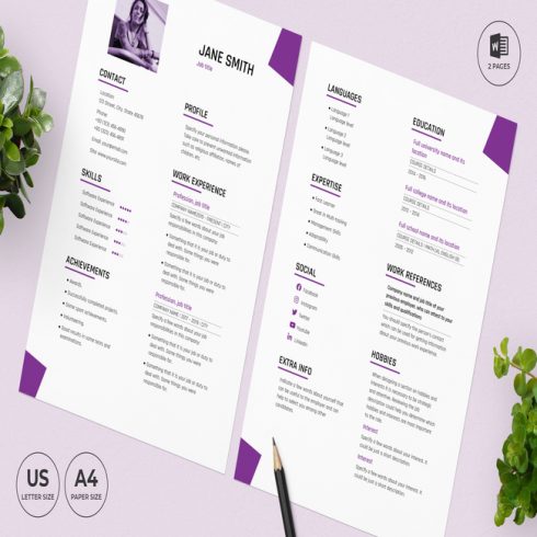 Purple and white resume on a table next to a plant.
