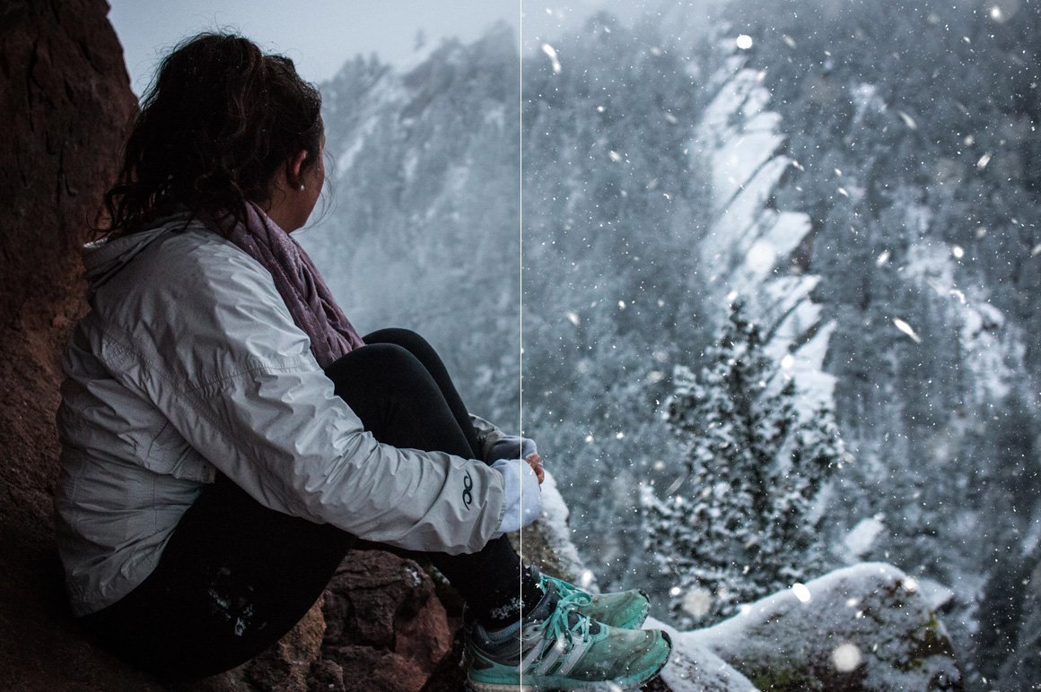 A beautiful girl sits in a cave and watches the snowfall from the mountain.