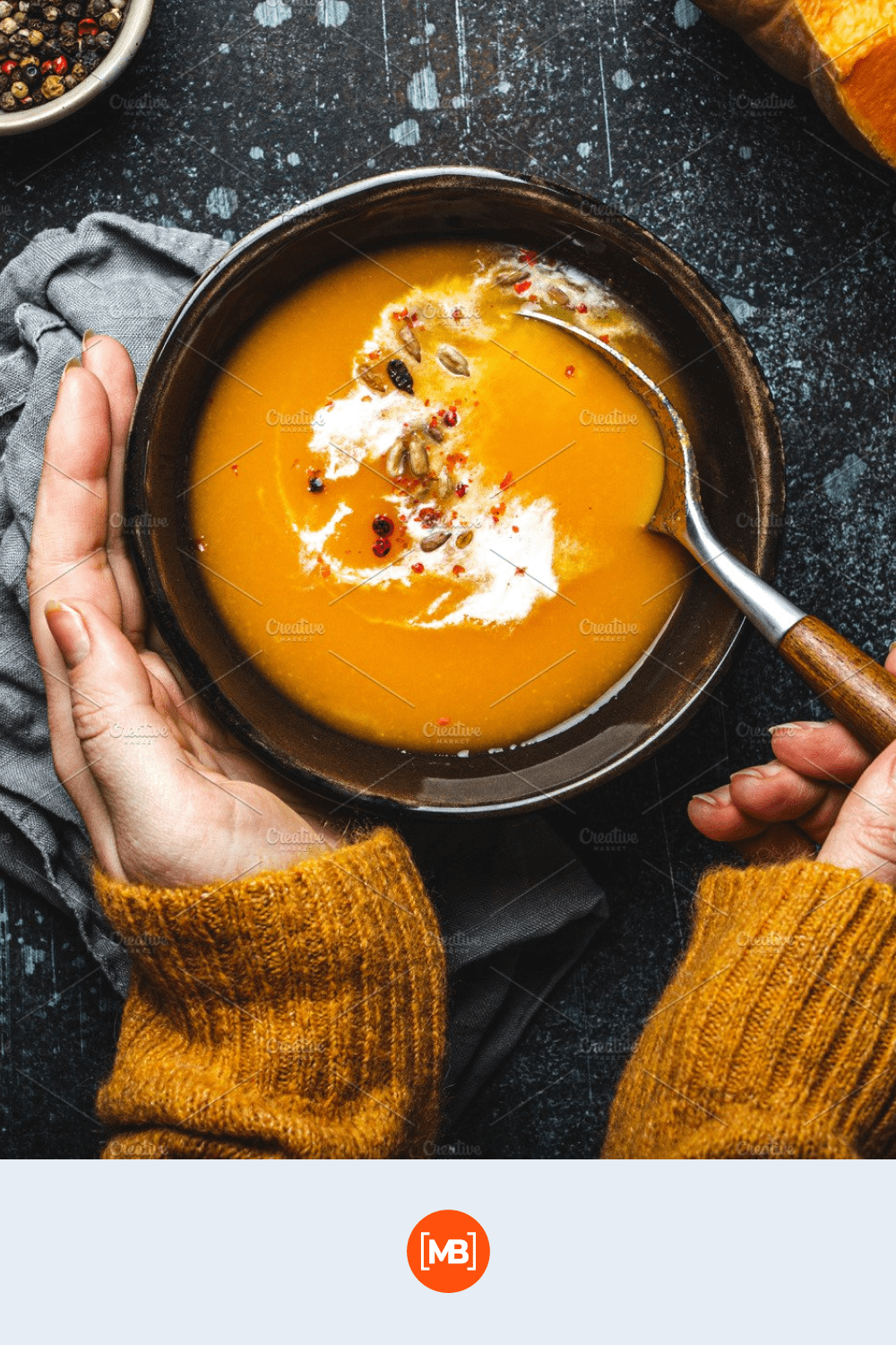 Background Female hands with a bowl of pumpkin soup.