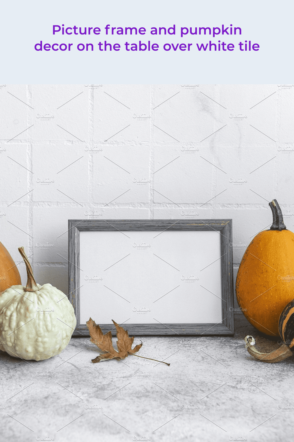 Picture frame and pumpkin decor on the table over white tile.