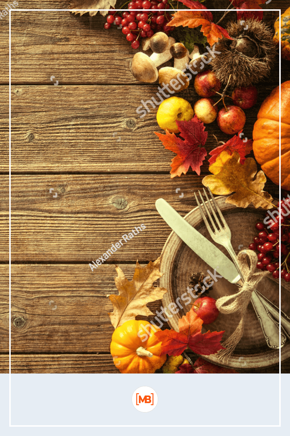 Autumn background from fallen leaves and fruits with vintage place setting on old wooden table.