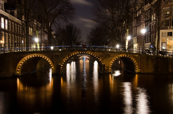 bridge and canals at night amsterdam netherlands small