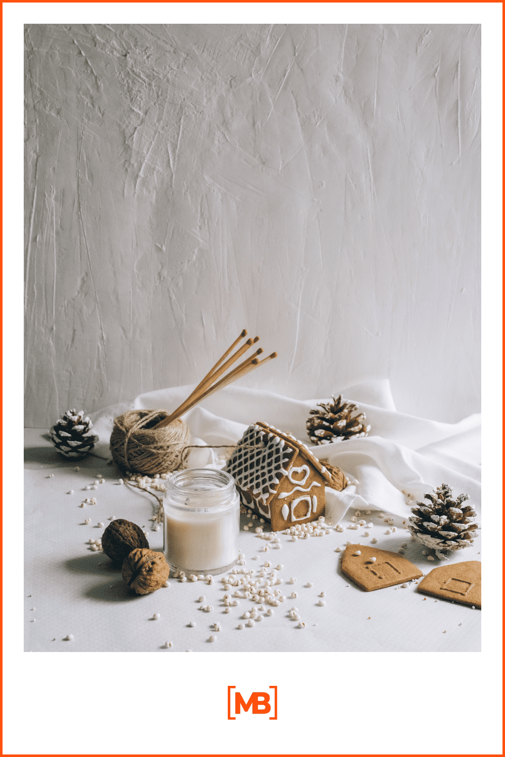 Gingerbread house, candles, cones and other decorations on a white background.