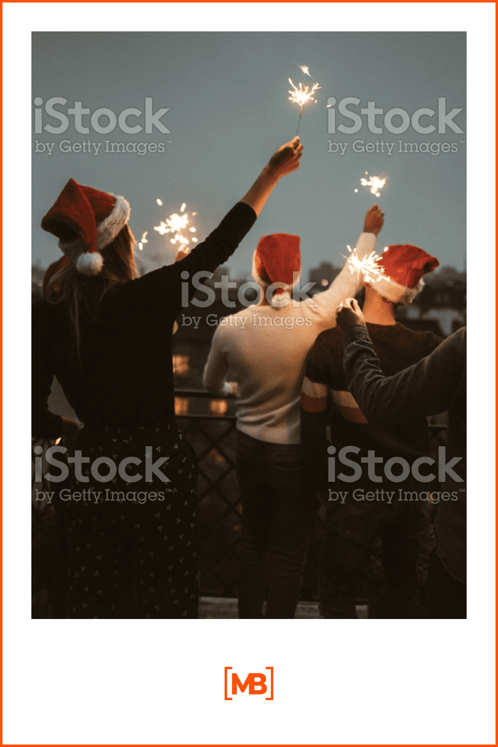 friends in Santa Claus hats with sparklers on the roof celebrating on rooftop.