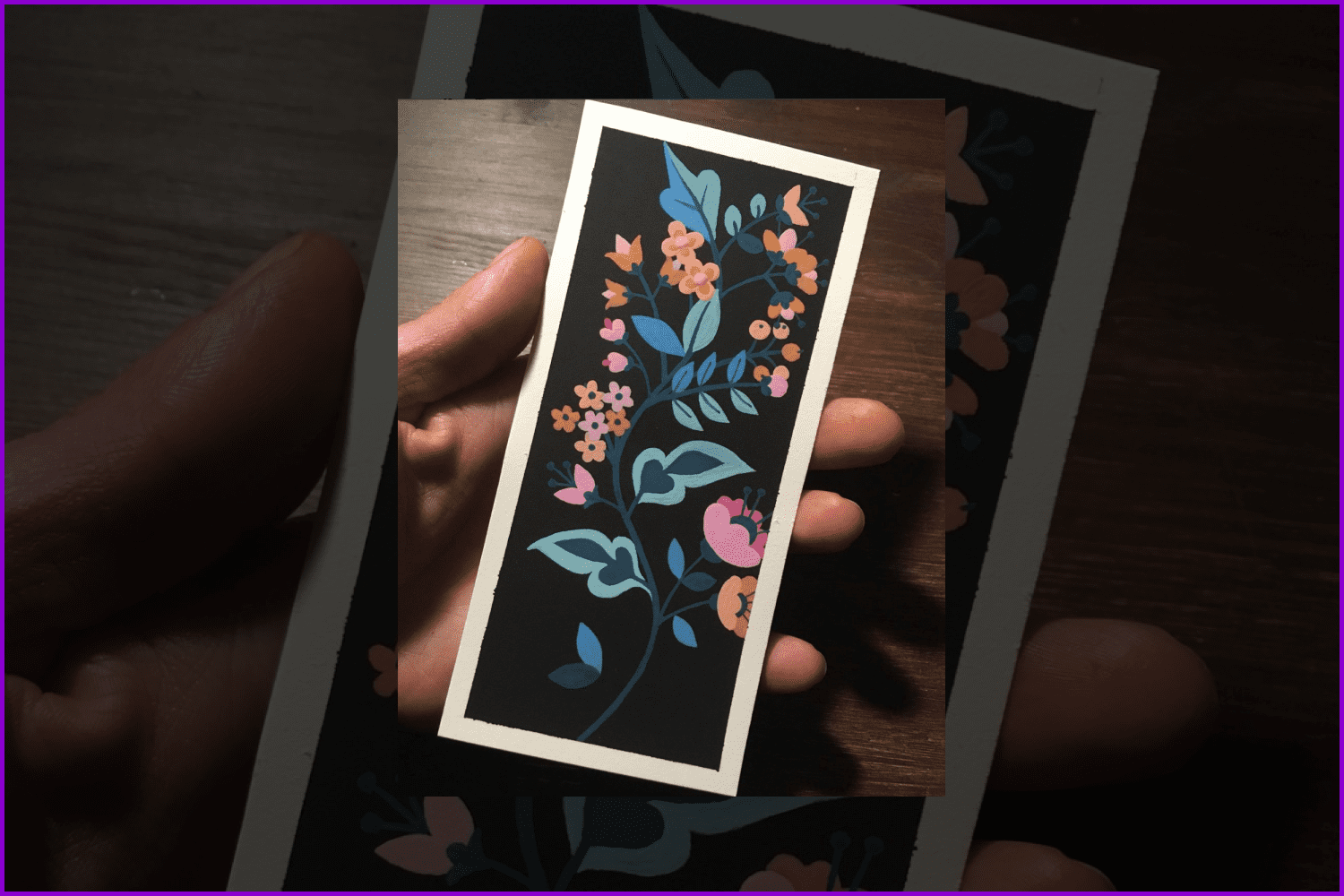 Rectangle bookmark with black background and flowers.