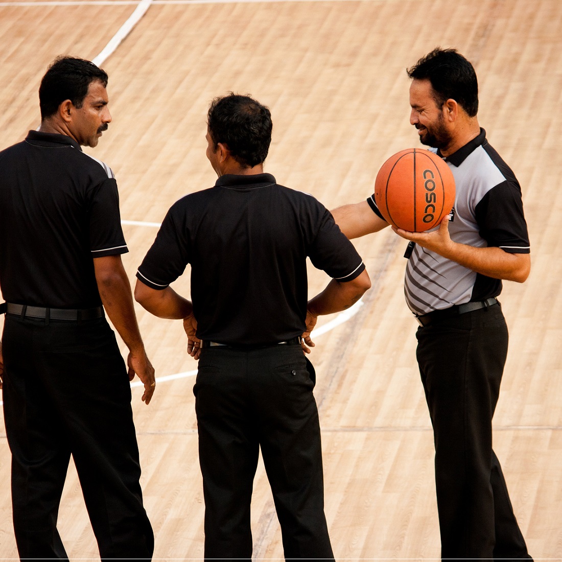 basketball referees on the court square