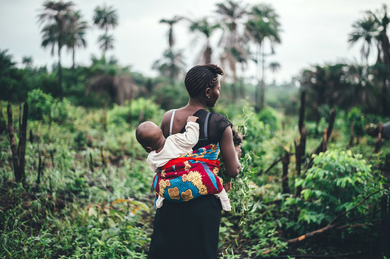 Mother carrying baby on back in Sierra Leone.