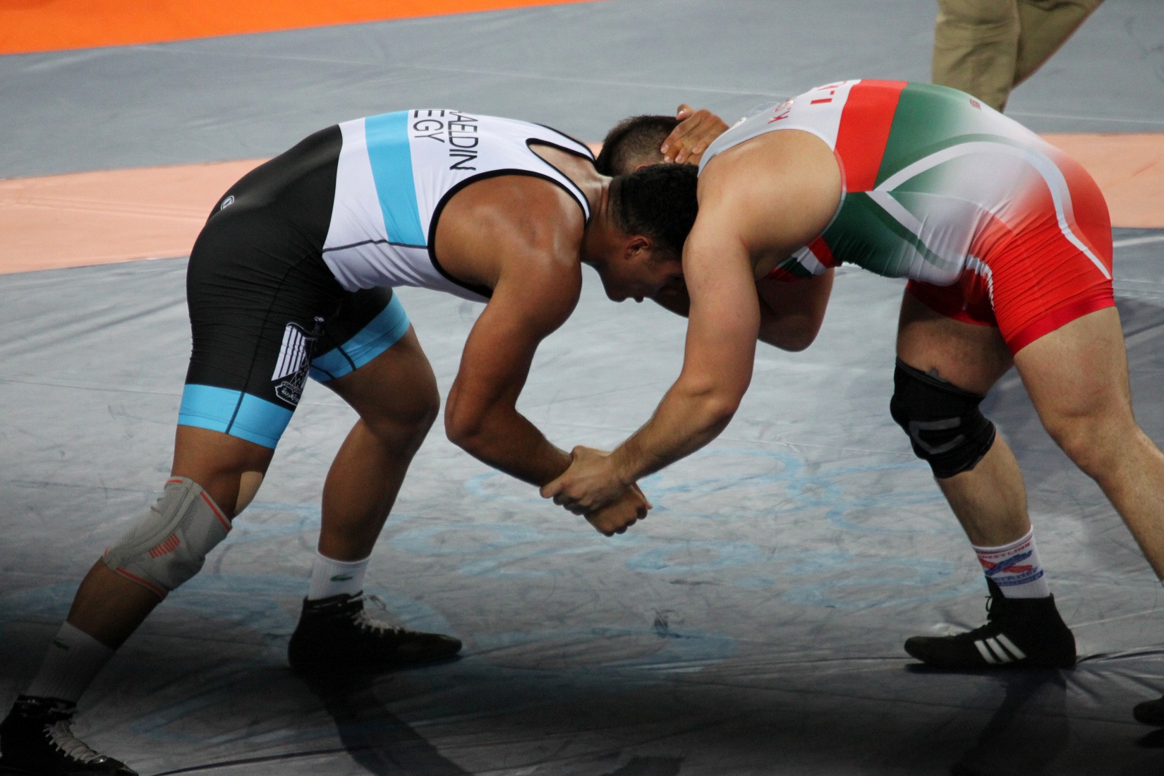 people wrestling in a match square