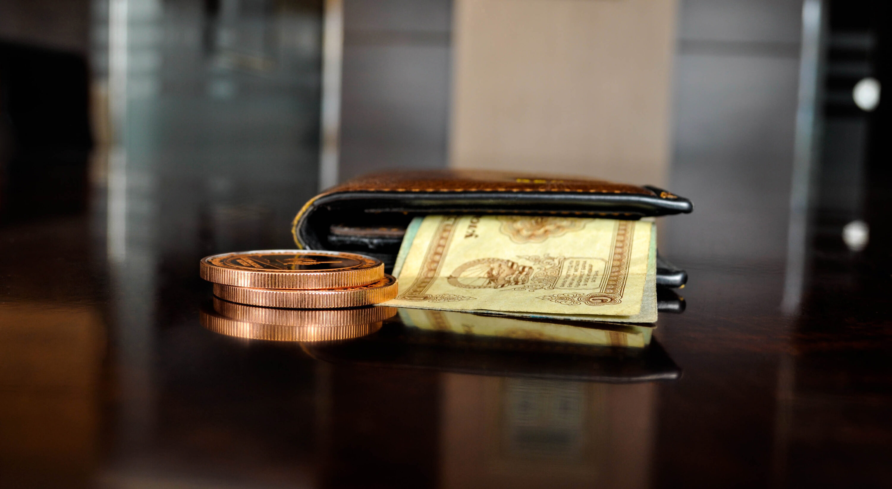Wallet with dollar papers and coins.