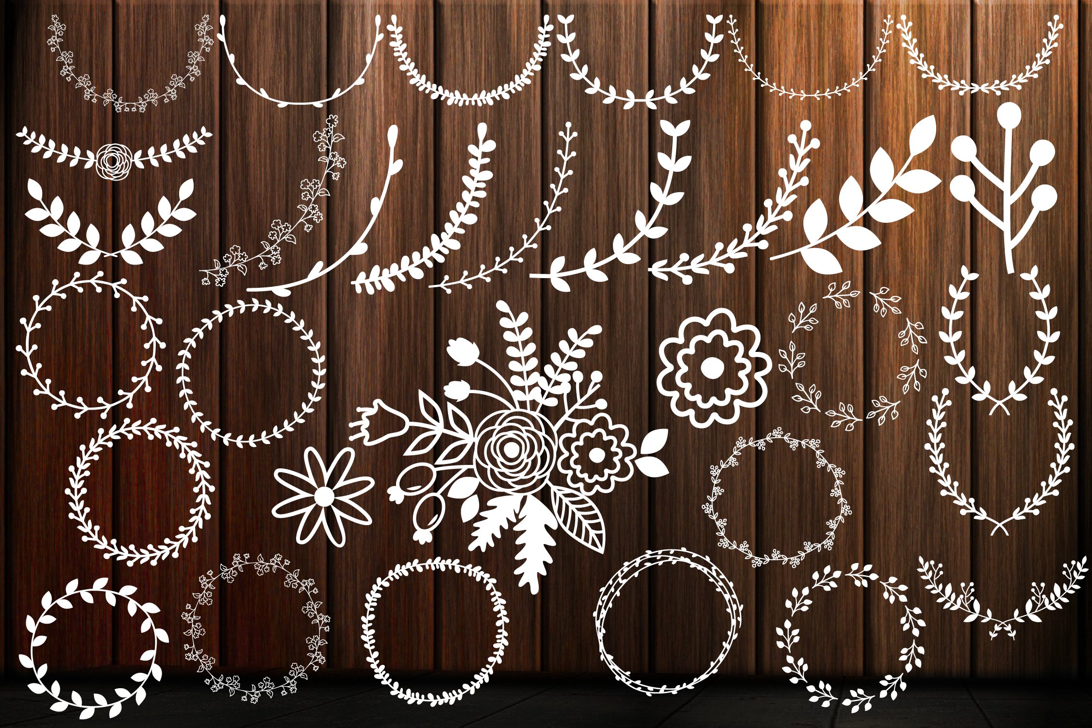 White wreaths on the wooden background.