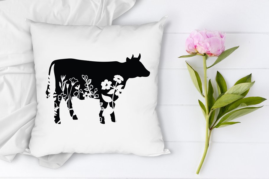 Pillow with a picture of a floral cow.