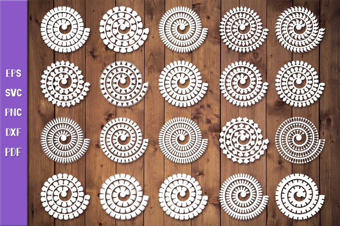 White rolled flowers with ornaments on the wooden background.