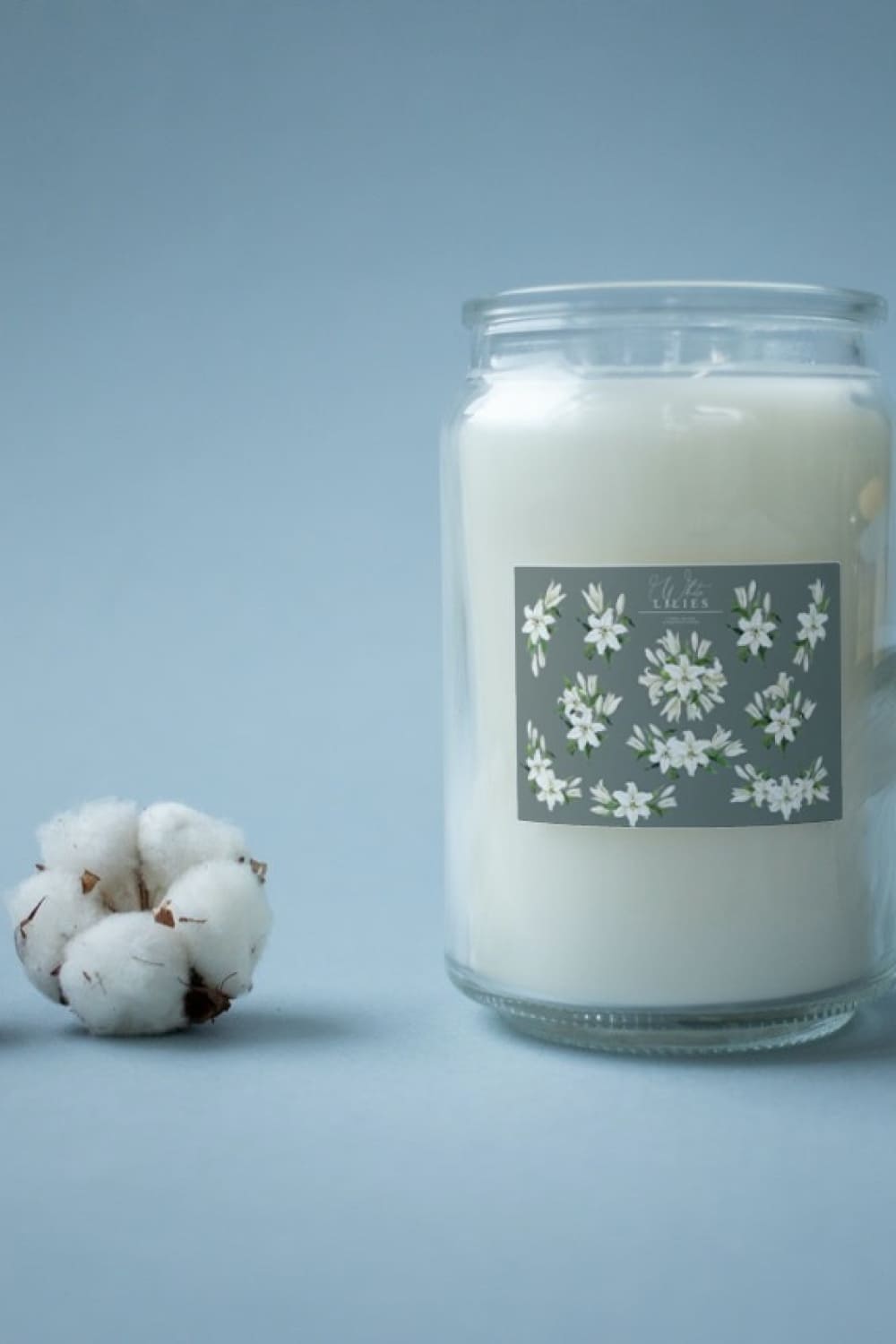 Beautiful candle with lily designed elements.