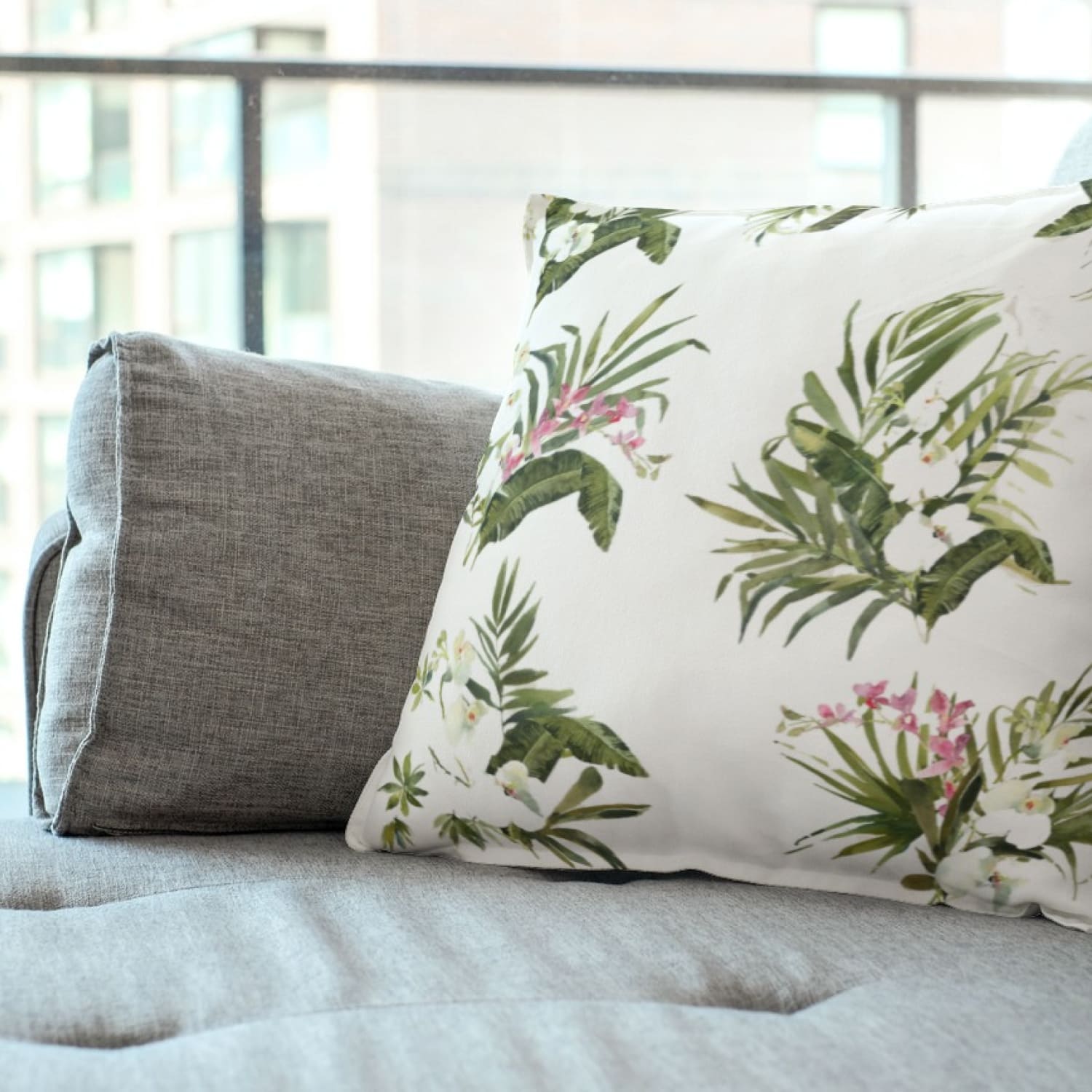 Pillow with white orchid tropic elements.