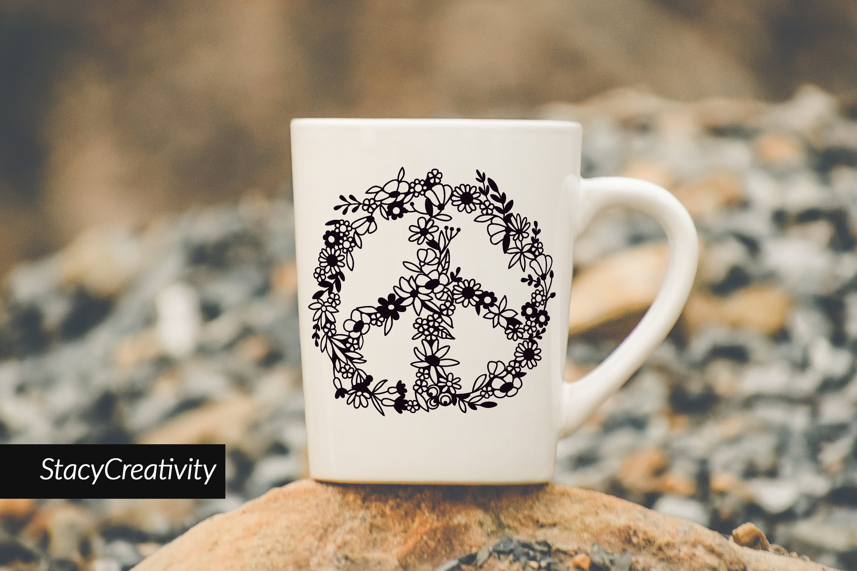 White cup with a floral peace sign.