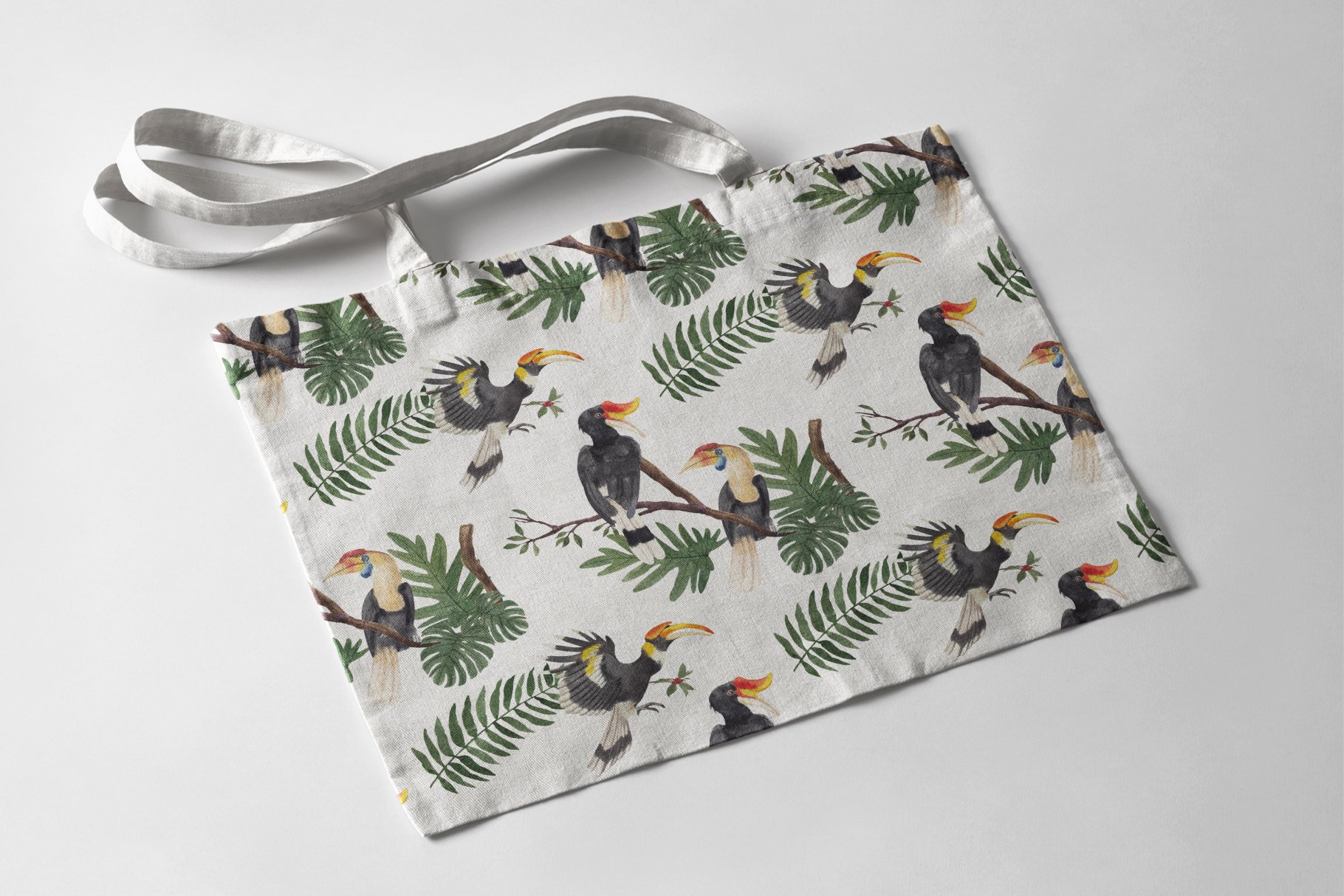 White bag with hornbills illustrations.