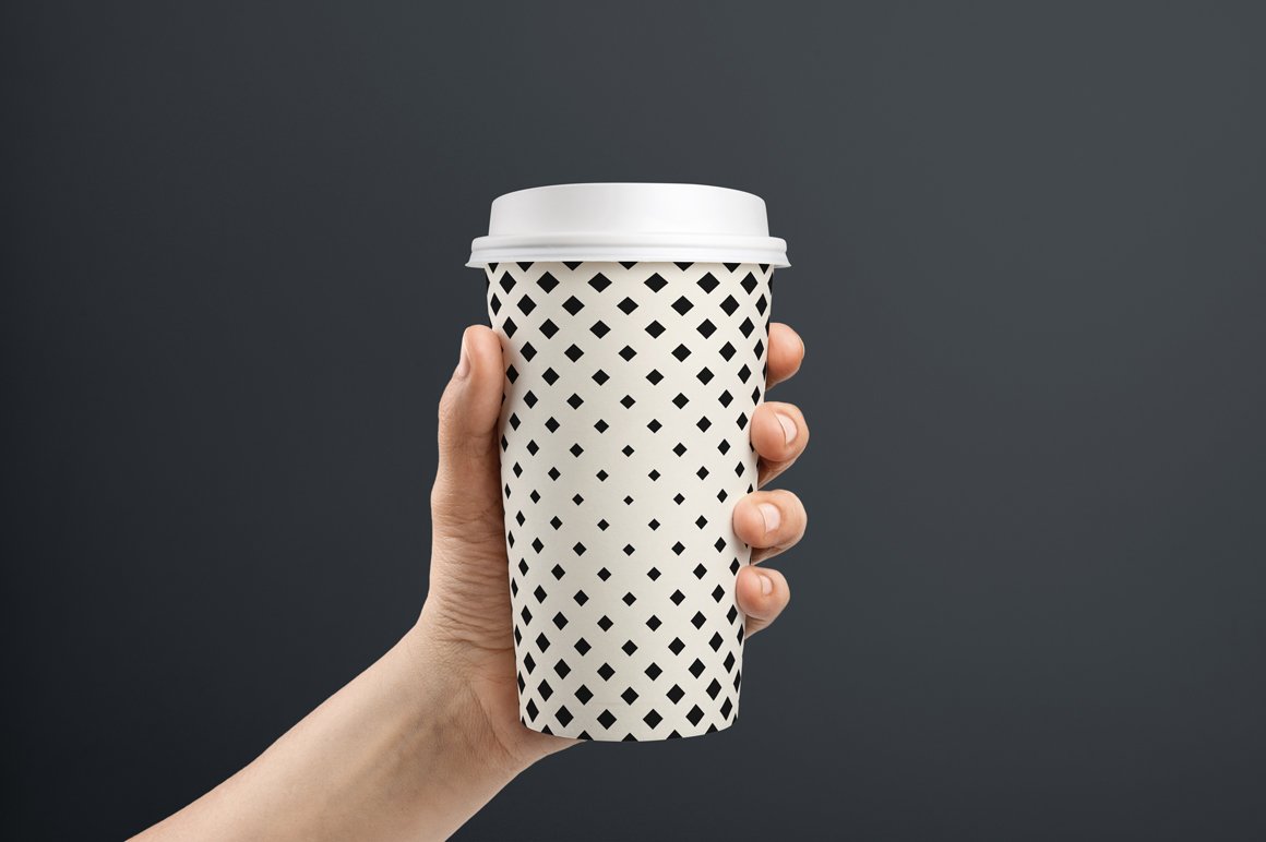 Stylish light paper cup with black geometrics.