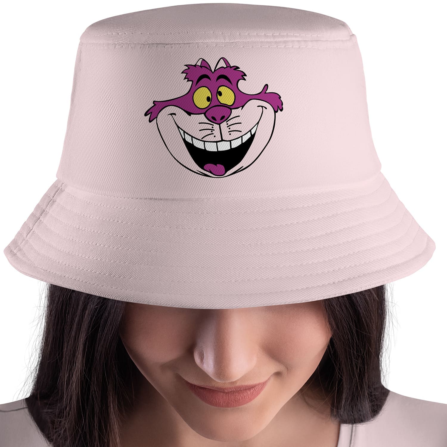 Woman wearing a pink hat with a goofy face on it.