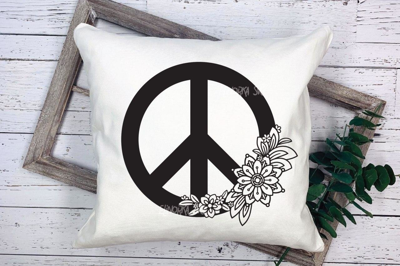 Decorate white pillow with a black floral peace symbol.