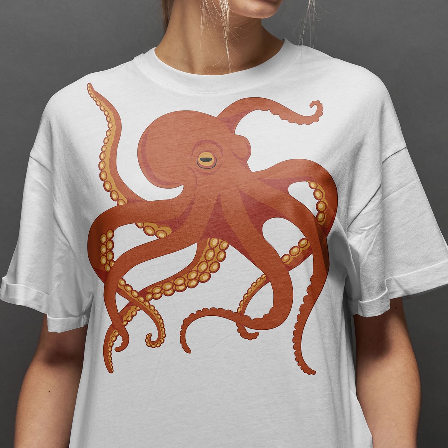 Woman wearing a white t - shirt with an orange octopus on it.