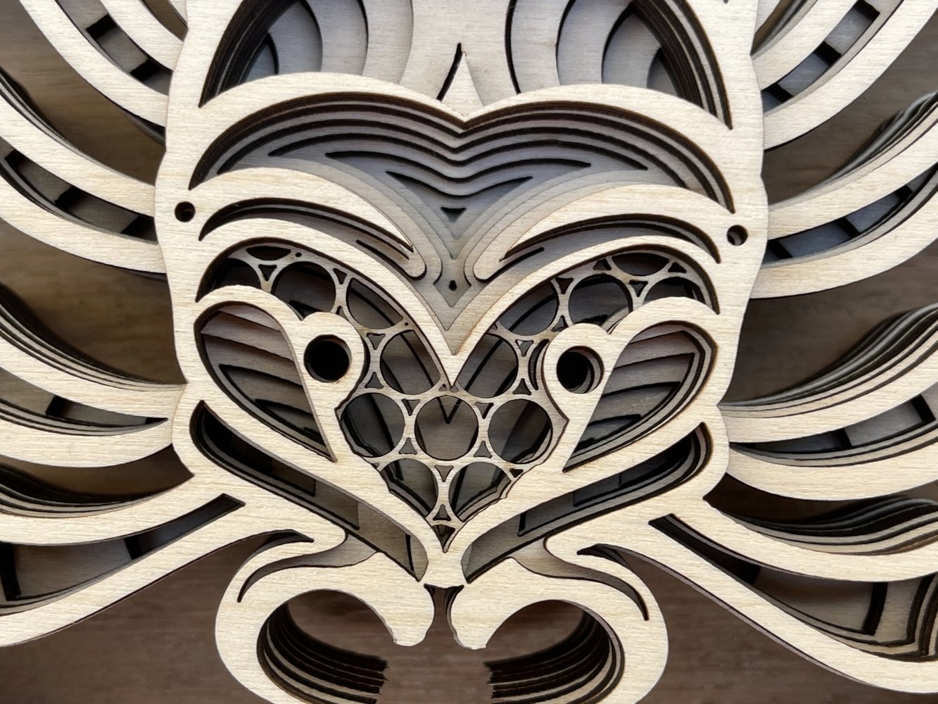 Close up of a clock with a heart on it.