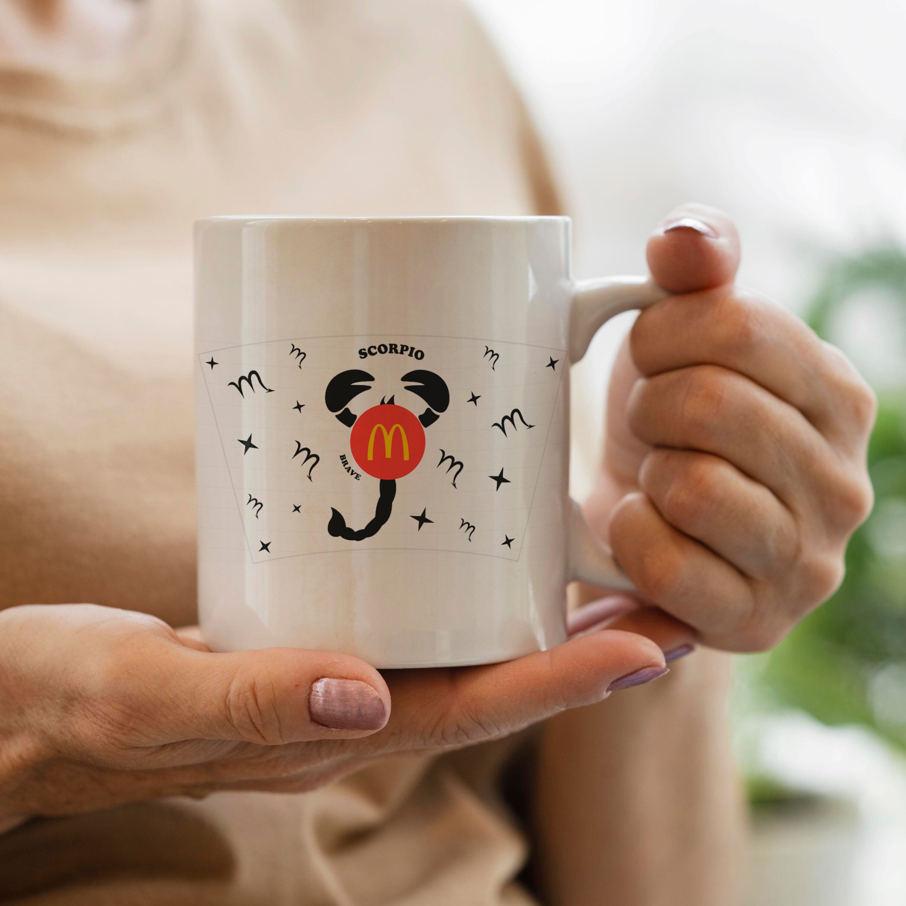 Woman holding a coffee mug with a mouse on it.