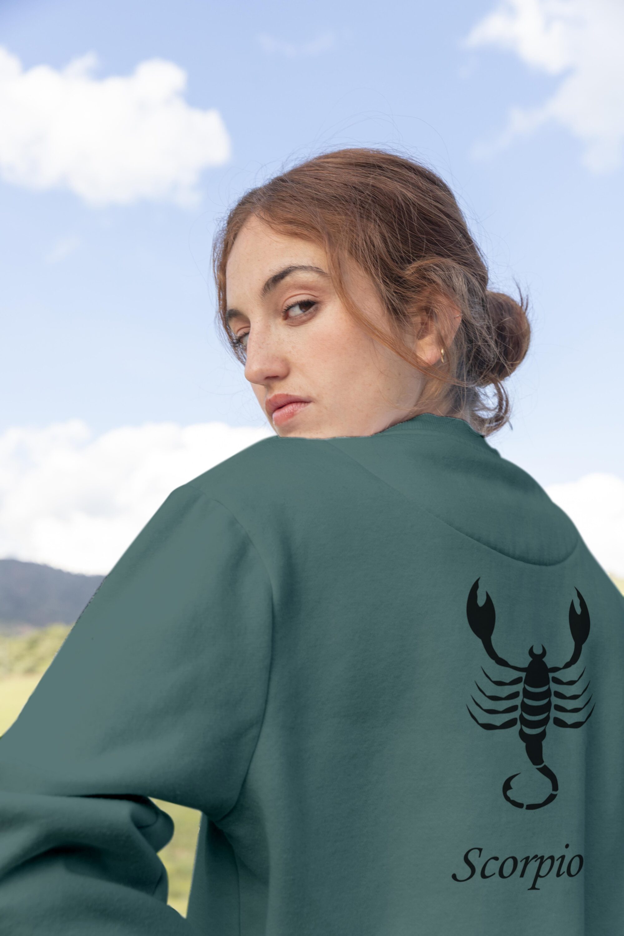 Woman wearing a sweatshirt with a scorpion on it.