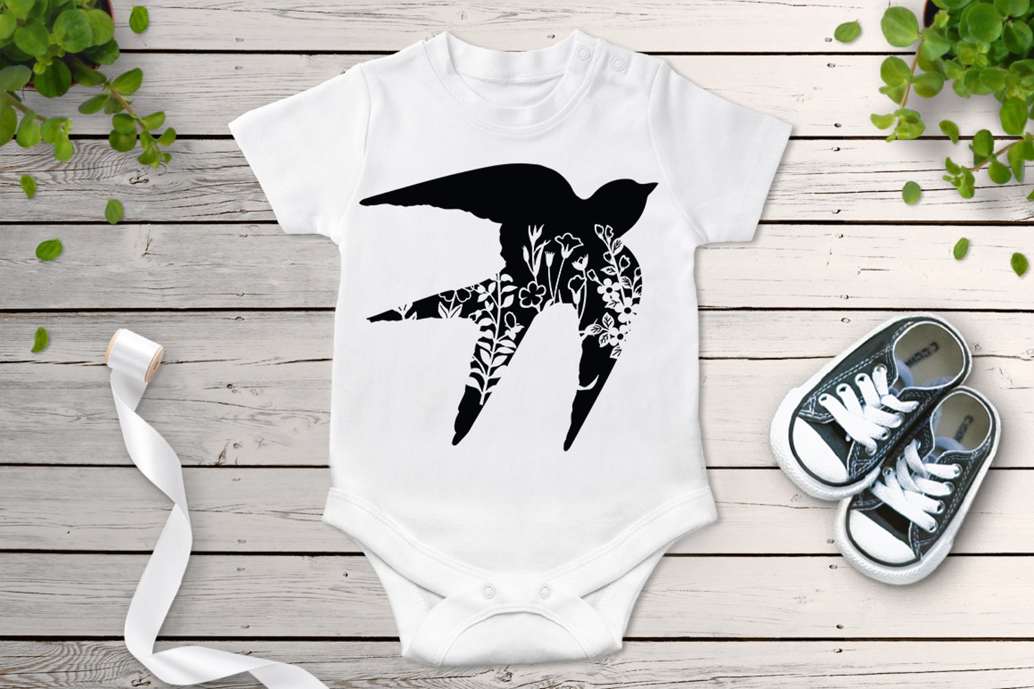 Baby bodysuit with a picture of a bird on it.