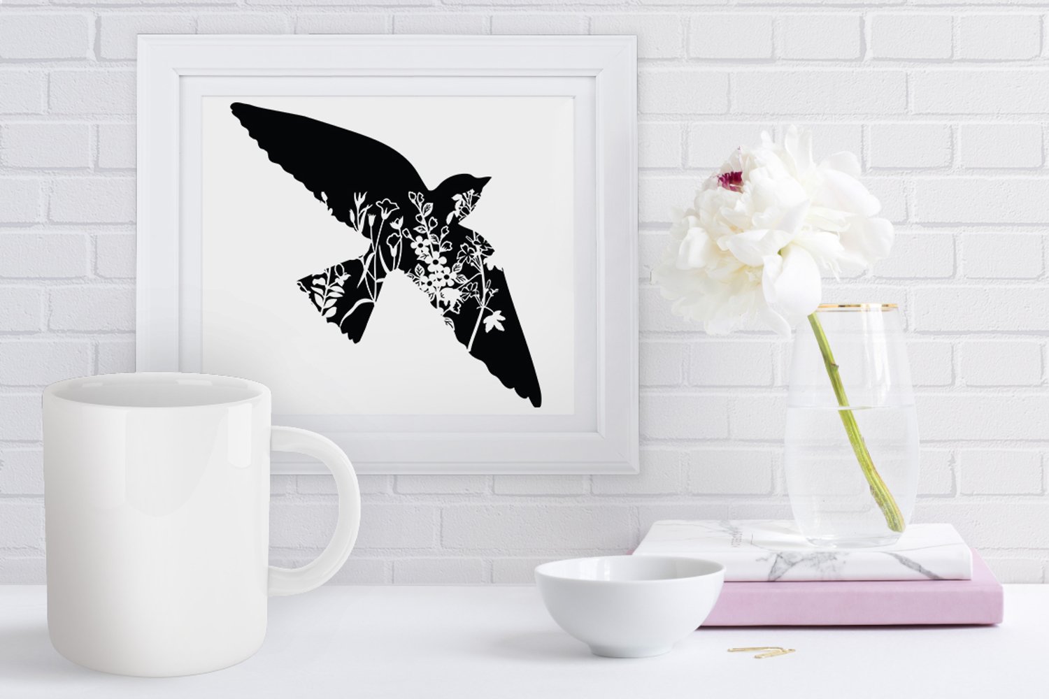 Picture of a bird on a wall next to a vase with flowers.