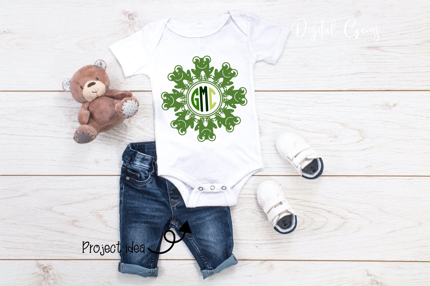 Baby bodysuit with a monogrammed design and a teddy bear.