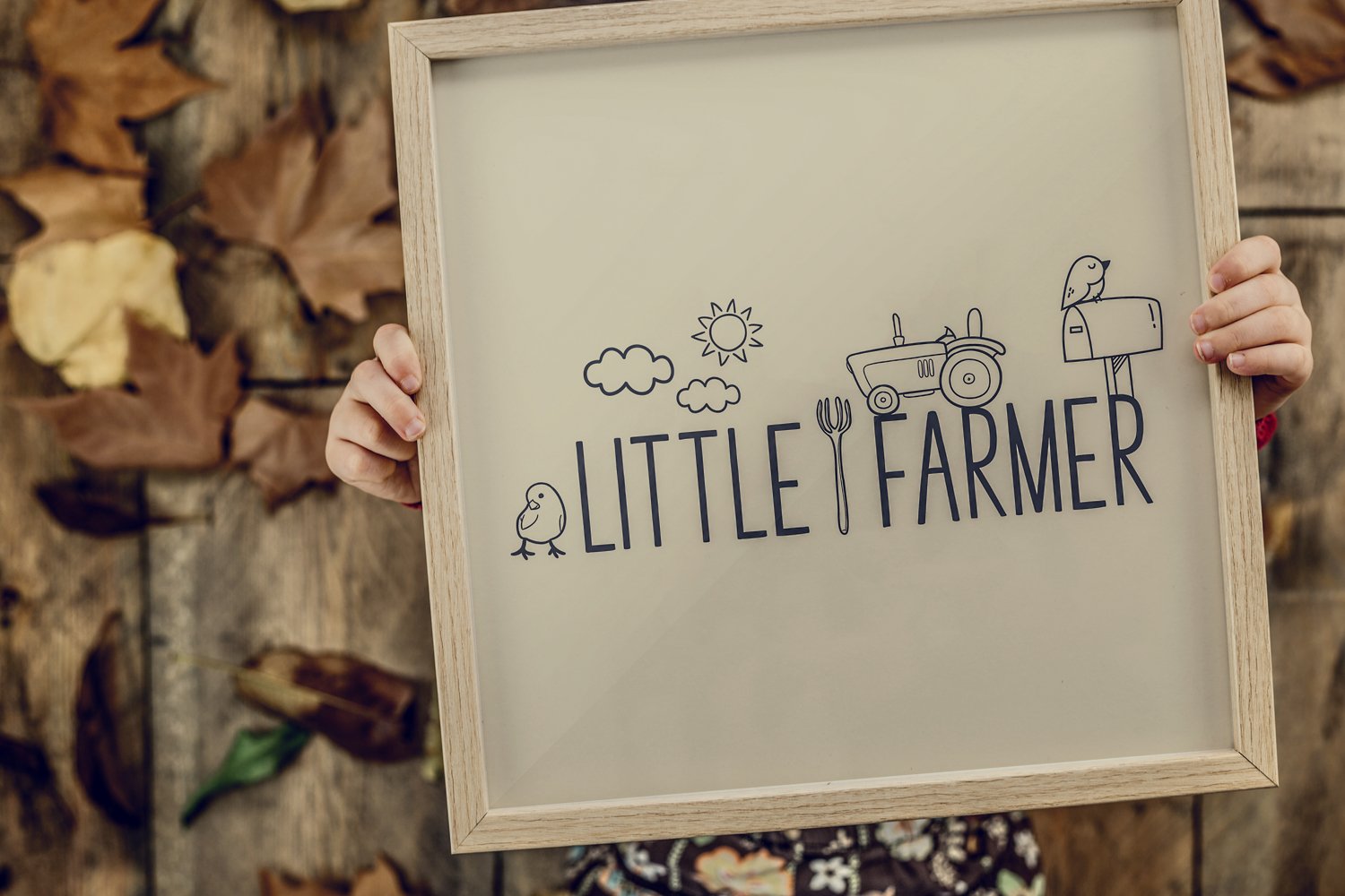 Person holding a sign that says little farmer.