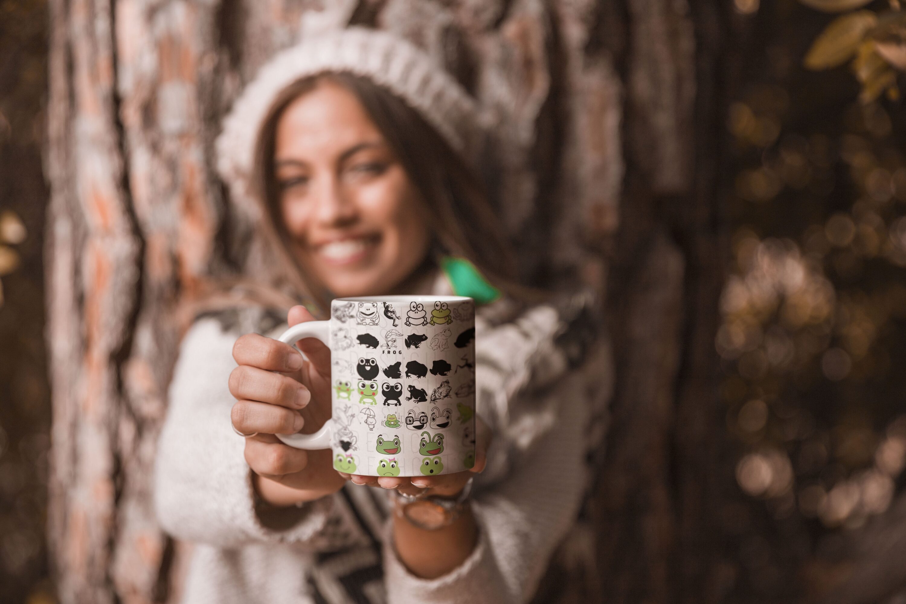 Woman holding a coffee mug in front of a tree.