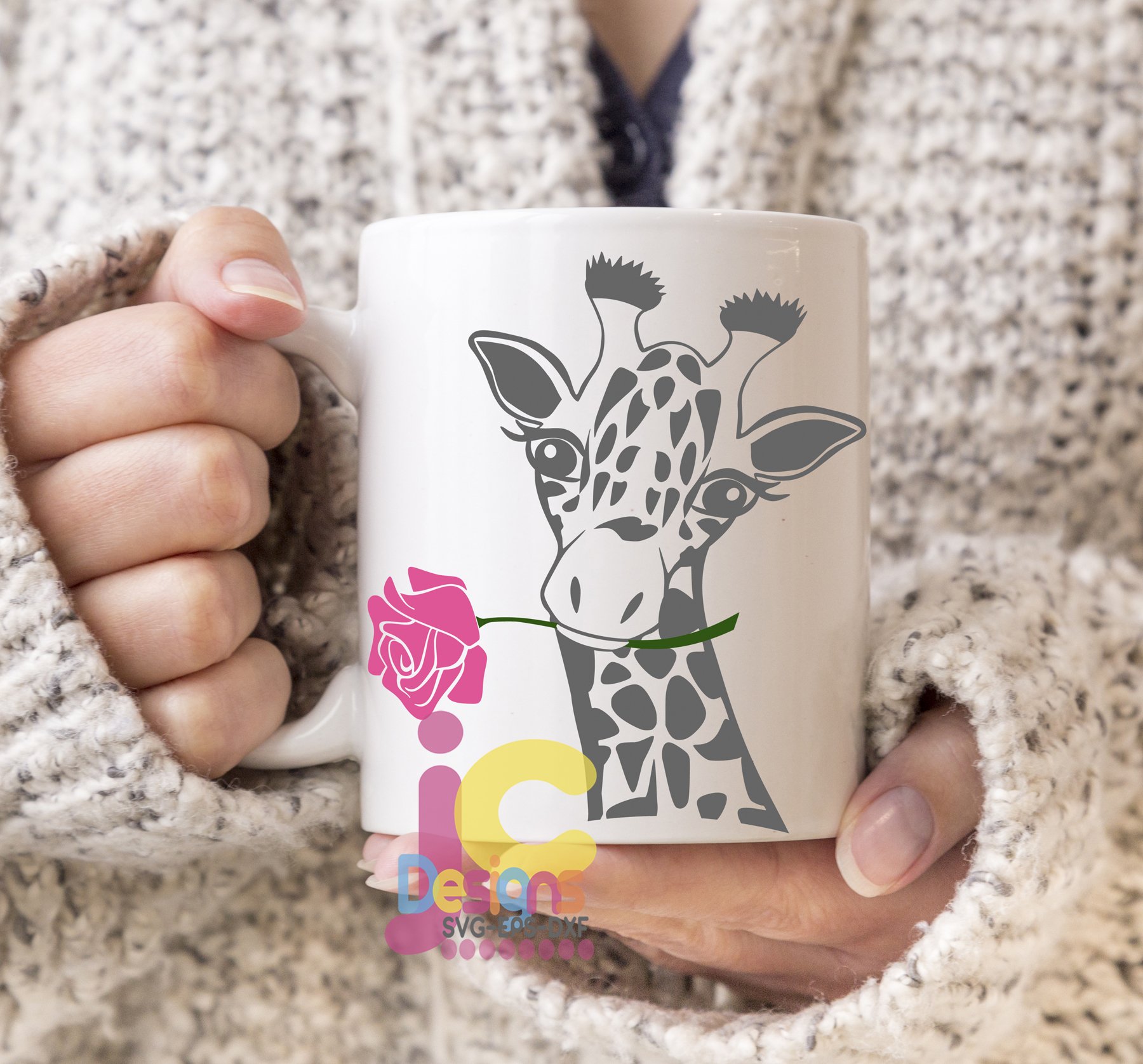 Person holding a coffee mug with a giraffe on it.