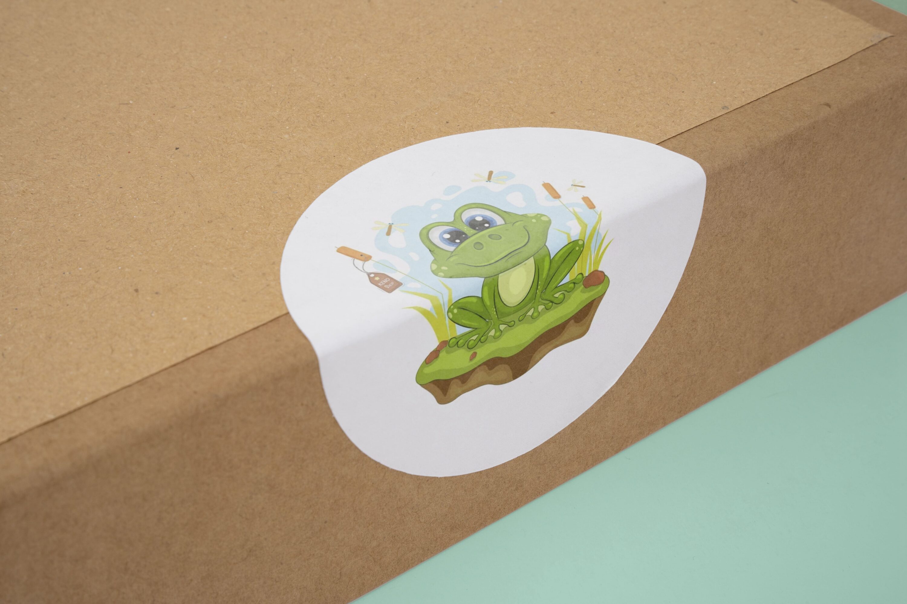 Cardboard box with a sticker of a frog on it.