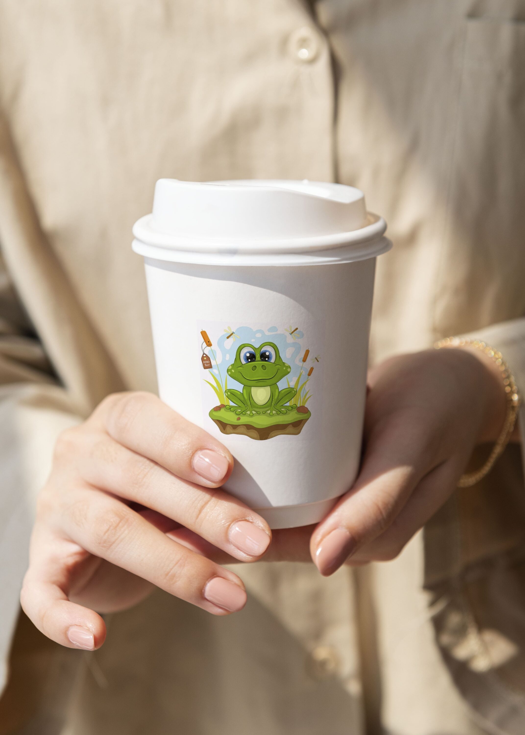 Cup illustrated with cartoon green frog.