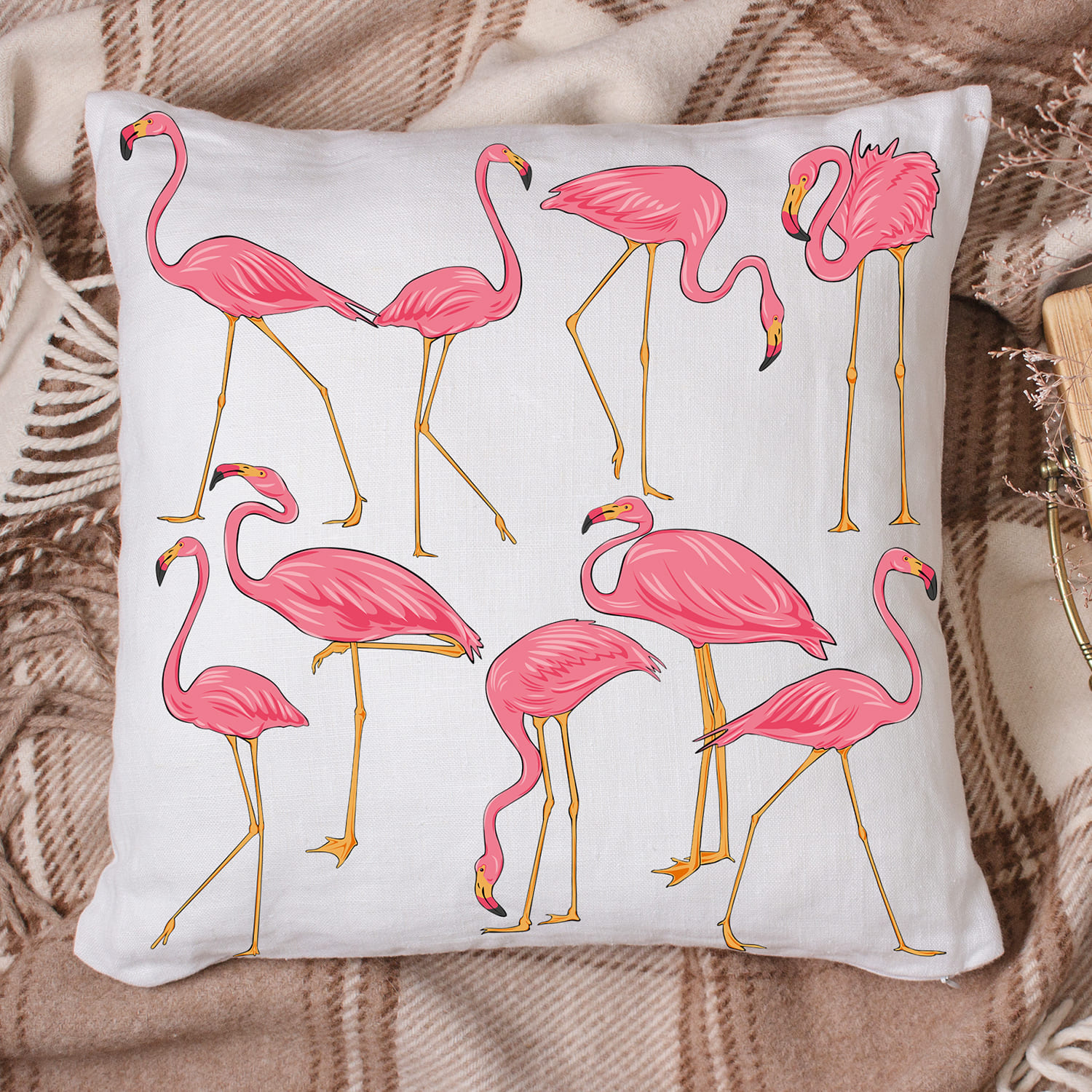 Pink flamingo pillow sitting on top of a bed.