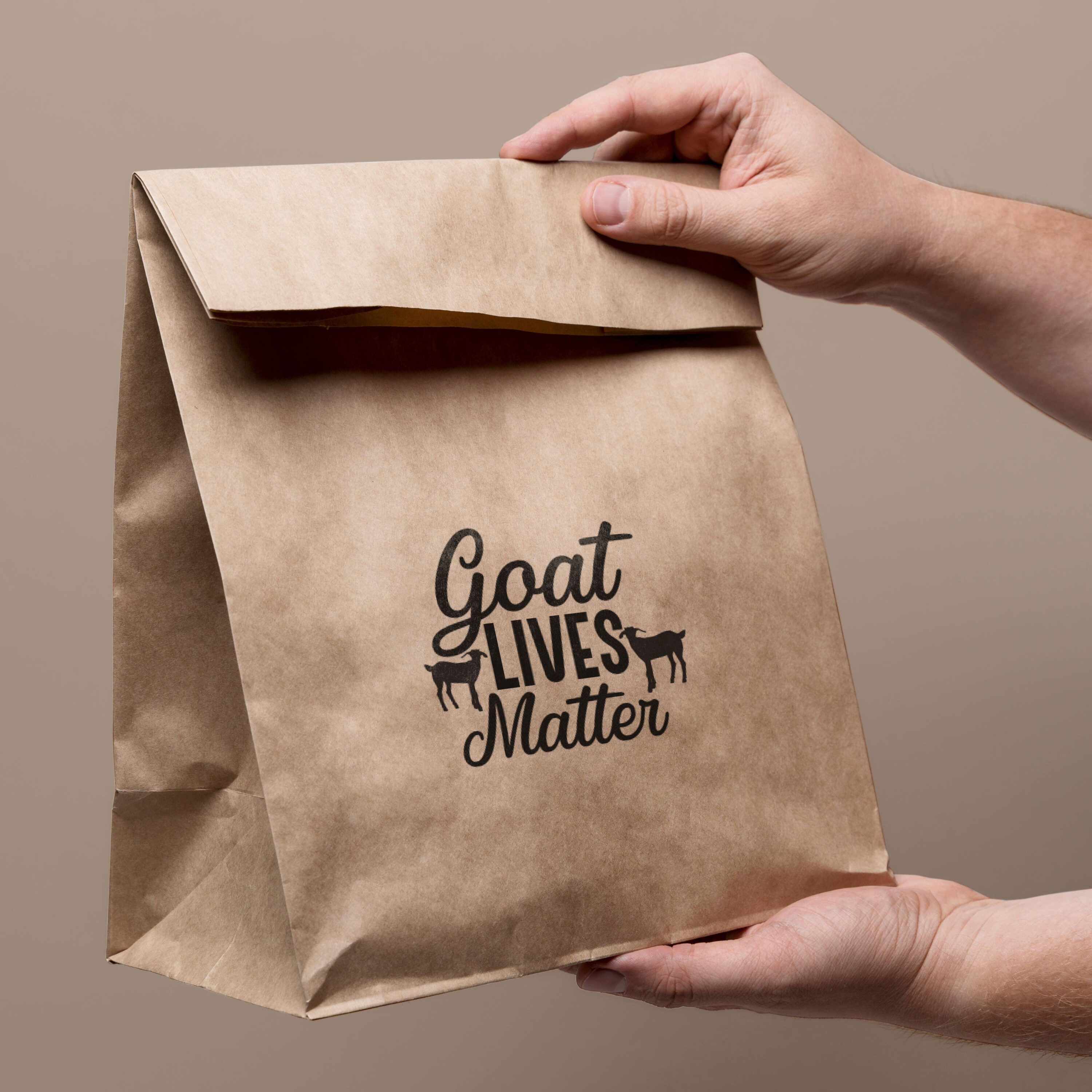 Person holding a brown paper bag that says goat lives matter.