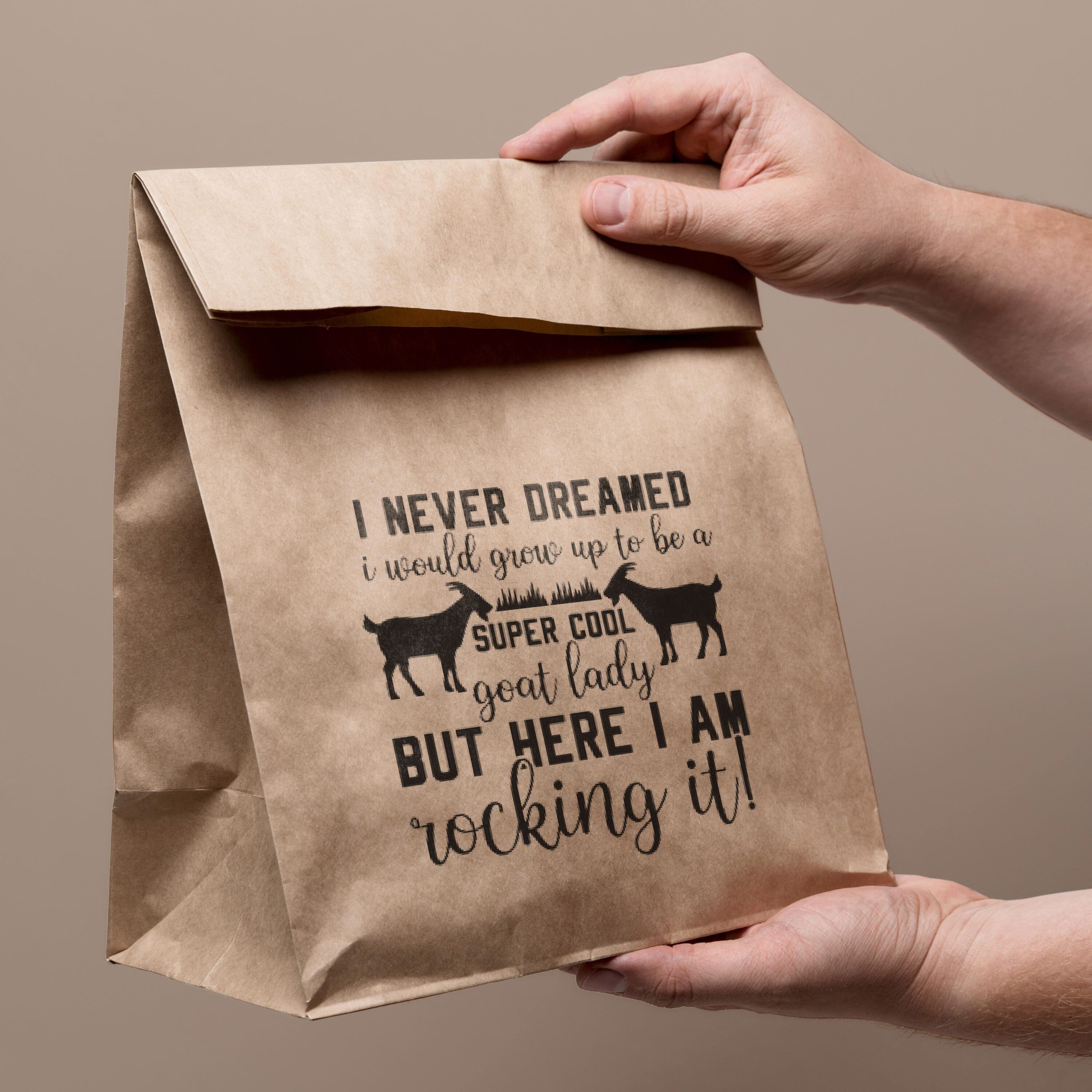 Person holding a brown paper bag with a quote on it.
