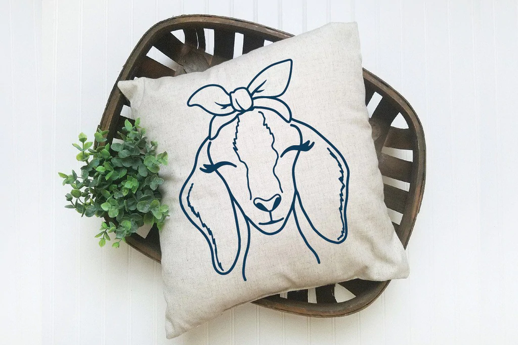 Pillow with a picture of a goat on it.