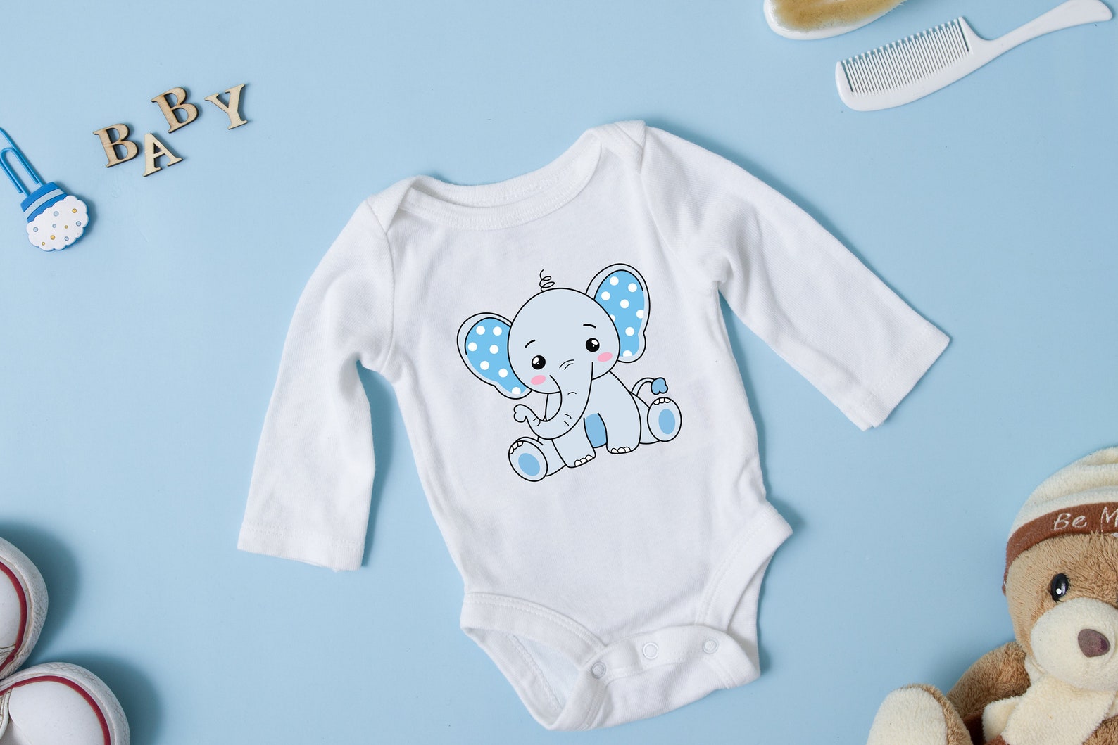 Baby bodysuit with a picture of an elephant on it.