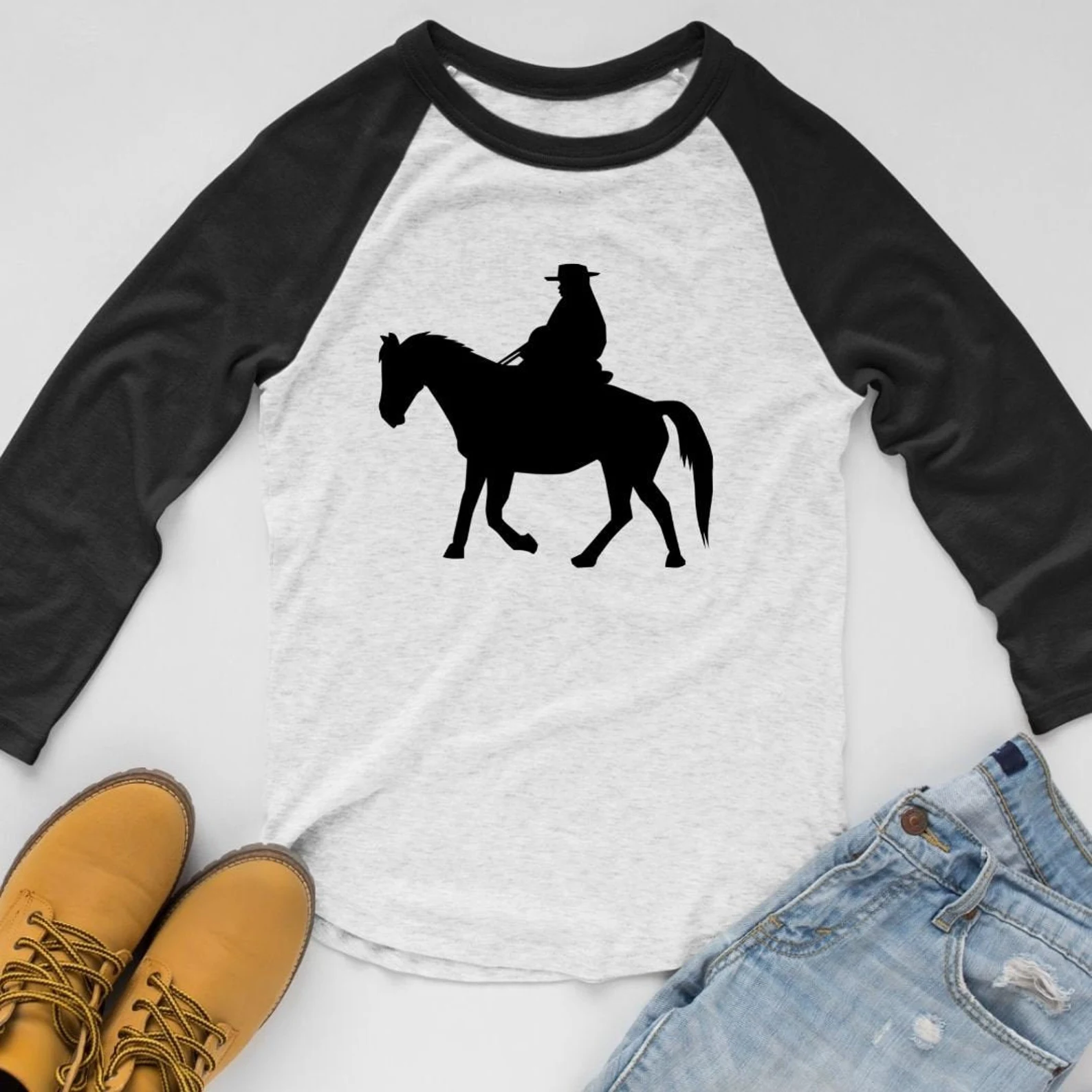 White and black sweater with a cowboy.