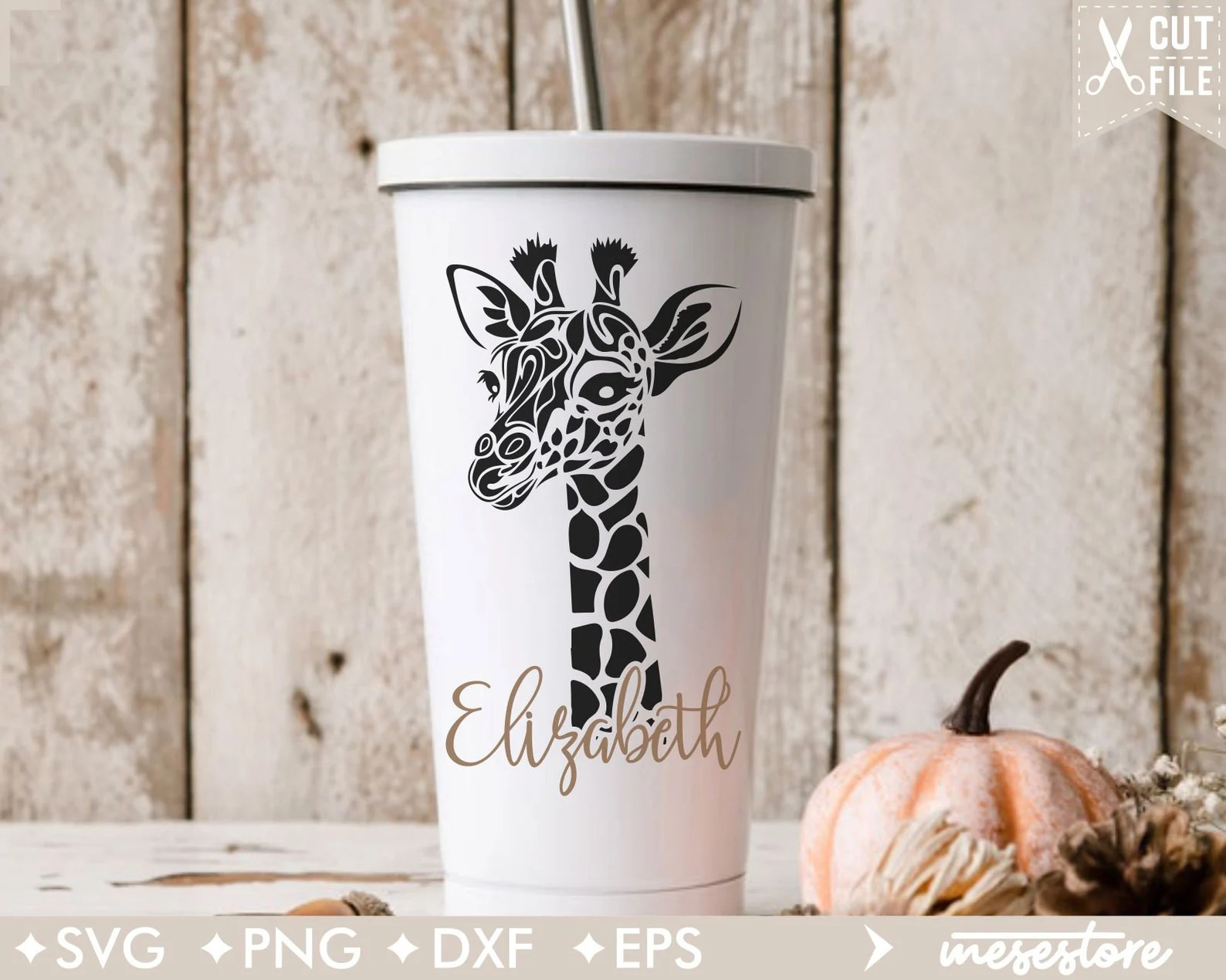 White cup with a giraffe on it next to a pumpkin.