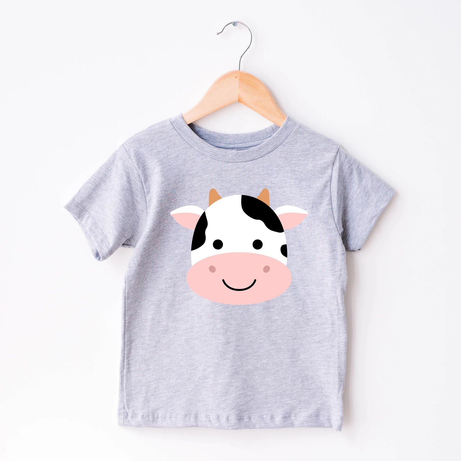 Gray t - shirt with a black and white cow on it.