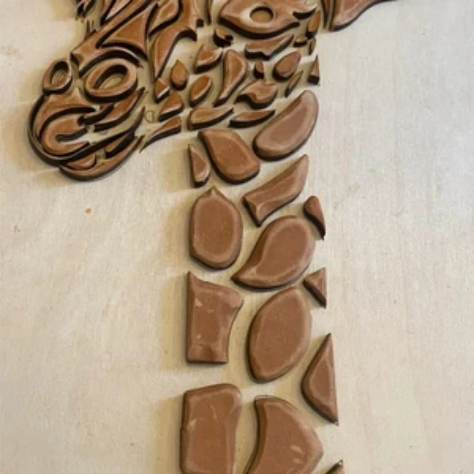 Giraffe made out of chocolate on a table.
