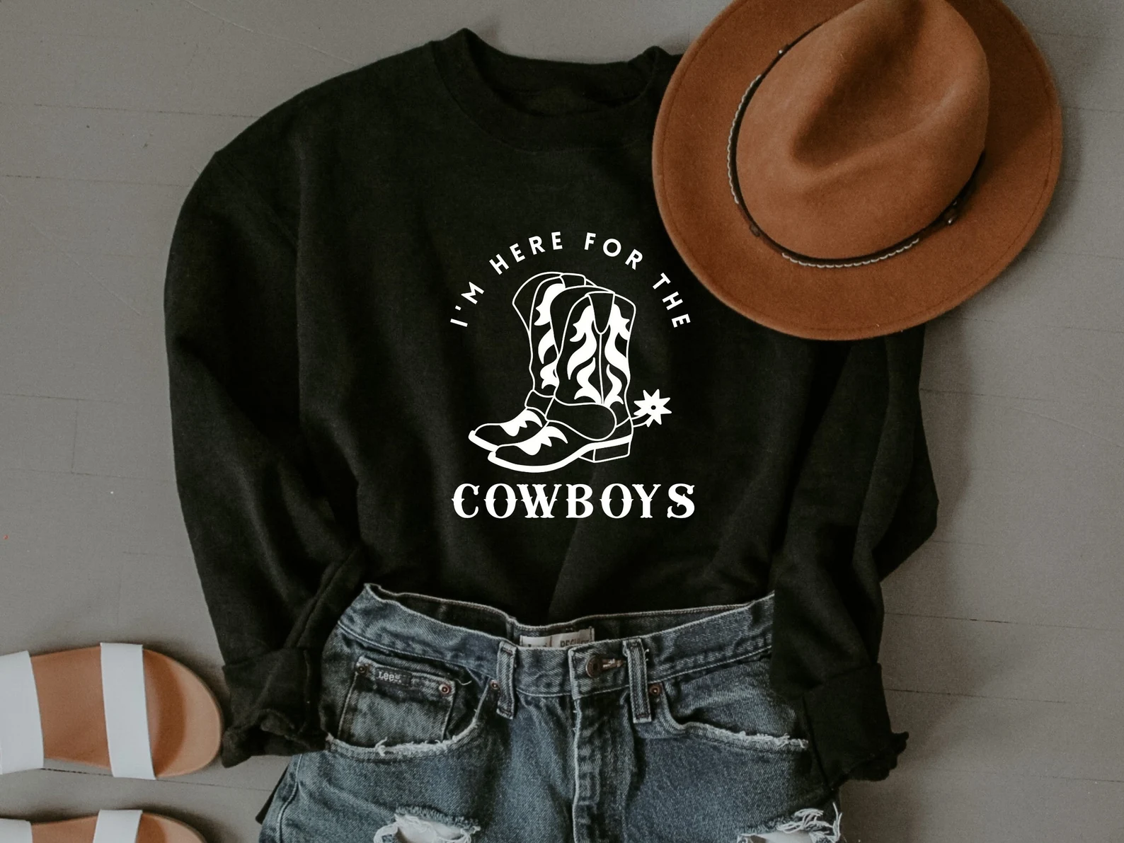 Black t-shirt with white cowboy boots.